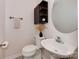 Small bathroom featuring a pedestal sink, wall-mounted cabinet, and modern fixtures at 713 Springfield Nw Dr, Concord, NC 28027