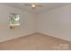 Neutral bedroom with carpet flooring, window with natural light, and ceiling fan at 713 Springfield Nw Dr, Concord, NC 28027