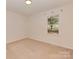 Empty carpeted bedroom with a window and neutral walls at 713 Springfield Nw Dr, Concord, NC 28027