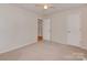 Carpeted bedroom with neutral walls, ceiling fan, and entry to hallway at 713 Springfield Nw Dr, Concord, NC 28027
