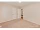 Bedroom with carpet flooring, neutral walls, and open doorways to other spaces at 713 Springfield Nw Dr, Concord, NC 28027