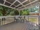 A covered deck features a table and two chairs, creating a cozy outdoor seating area at 713 Springfield Nw Dr, Concord, NC 28027