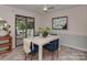 Dining area with patio access, stylish decor, a bright table setting, and plenty of natural light at 713 Springfield Nw Dr, Concord, NC 28027