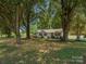 Traditional home with mature trees, showcasing a well-maintained lawn and inviting curb appeal at 713 Springfield Nw Dr, Concord, NC 28027