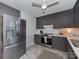 Modern kitchen boasts stainless steel appliances, gray cabinets, plenty of counter space, and a bright, airy feel at 713 Springfield Nw Dr, Concord, NC 28027