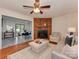 Inviting living room with a wood-burning fireplace, stylish furnishings, and an open view to the dining area at 713 Springfield Nw Dr, Concord, NC 28027