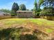 Spacious backyard featuring a large grassy area, privacy fence, and mature trees at 7134 Rollingridge Dr, Charlotte, NC 28211