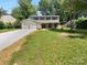 Charming two-story home featuring a two-car garage, neutral siding, and lush landscaping at 7134 Rollingridge Dr, Charlotte, NC 28211