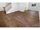 Empty living room with hardwood flooring, staircase, and natural light. Ready to be furnished! at 7134 Rollingridge Dr, Charlotte, NC 28211