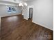 Open-concept living room featuring hardwood floors and modern chandelier lighting at 7134 Rollingridge Dr, Charlotte, NC 28211