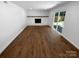Spacious living room with hardwood floors, brick fireplace, and sliding doors to patio at 7134 Rollingridge Dr, Charlotte, NC 28211
