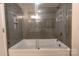 Modern bathroom with a glass-enclosed shower and a large tub at 720 Governor Morrison St # 221, Charlotte, NC 28211