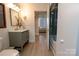 Bathroom with modern vanity, walk-in shower, and neutral color palette at 720 Governor Morrison St # 221, Charlotte, NC 28211