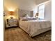 Serene bedroom featuring a tufted headboard, mirrored nightstands, and plush bedding for ultimate relaxation at 720 Governor Morrison St # 221, Charlotte, NC 28211