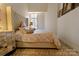 Comfortable bedroom showcasing a tufted headboard, elegant bedding, and soft natural light through the window at 720 Governor Morrison St # 221, Charlotte, NC 28211
