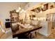 Elegant dining area showcasing modern lighting fixtures and a glimpse of the stainless steel kitchen appliances at 720 Governor Morrison St # 221, Charlotte, NC 28211