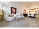Airy living room boasts a plush sofa, striking art, and an open view to the stylish dining area and kitchen at 720 Governor Morrison St # 221, Charlotte, NC 28211