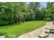Lush backyard with mature trees and a charming swing set at 748 Land Fall Dr, Rock Hill, SC 29732