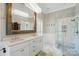 A luxurious bathroom featuring a double vanity, a large mirror, and a glass-enclosed shower at 748 Land Fall Dr, Rock Hill, SC 29732