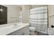 Bright bathroom with vanity and shower with striped curtain at 748 Land Fall Dr, Rock Hill, SC 29732