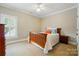 Cozy bedroom with neutral walls, plush carpet, and wooden bed frame at 748 Land Fall Dr, Rock Hill, SC 29732