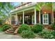 Inviting front porch with brick steps, columns, and decorative plants, creating a warm entrance at 748 Land Fall Dr, Rock Hill, SC 29732