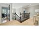 Hallway with a black staircase, hardwood floors, and a view of a dining room at 748 Land Fall Dr, Rock Hill, SC 29732