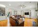 Spacious living room with leather sectional, hardwood floors, built-in shelves, and a large ceiling fan at 748 Land Fall Dr, Rock Hill, SC 29732