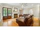 Elegant living room featuring a fireplace, a leather sofa, and French doors to add warmth and character at 748 Land Fall Dr, Rock Hill, SC 29732