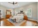 Spacious main bedroom with hardwood floors, a ceiling fan, and bright natural light, exuding comfort at 748 Land Fall Dr, Rock Hill, SC 29732