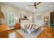 Spacious main bedroom with hardwood floors, neutral tones, a ceiling fan, and bright natural light at 748 Land Fall Dr, Rock Hill, SC 29732
