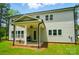 Covered porch featuring ceiling fan overlooking lush green lawn and trees at 7818 Russell Rd, Indian Trail, NC 28079