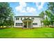 Two story home with backyard featuring lush lawn and perimeter of trees at 7818 Russell Rd, Indian Trail, NC 28079