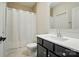 Neutral toned bathroom featuring a shower with curtain and dark colored vanity at 7818 Russell Rd, Indian Trail, NC 28079