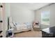 Sunlit bedroom features a plush chair and ottoman alongside a day bed at 7818 Russell Rd, Indian Trail, NC 28079
