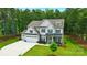 Beautiful two-story home with a three-car garage and well-manicured lawn at 7818 Russell Rd, Indian Trail, NC 28079