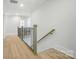 Upstairs hallway with neutral paint, wood floors, and access to multiple rooms at 7818 Russell Rd, Indian Trail, NC 28079