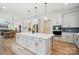 Open kitchen with a large island, white cabinets, and stainless steel oven at 7818 Russell Rd, Indian Trail, NC 28079