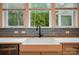 Beautiful kitchen with farmhouse sink, quartz countertops and view of mature trees at 7818 Russell Rd, Indian Trail, NC 28079