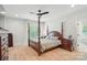 Spacious main bedroom with ceiling fan, wood floors, and natural light at 7818 Russell Rd, Indian Trail, NC 28079