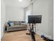 Bright workout room with a couch, exercise bike, and modern light wood flooring at 7818 Russell Rd, Indian Trail, NC 28079