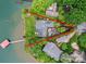 Aerial view of lakefront property with lush landscaping, private dock and ample parking space at 7945 Placid Ct, Denver, NC 28037