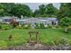 Stunning lake home showcasing beautiful landscaping, stone borders and lush green lawn at 7945 Placid Ct, Denver, NC 28037