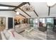Bright open living space featuring beamed ceilings, a windmill fan and lake views at 7945 Placid Ct, Denver, NC 28037