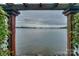 Serene waterfront view framed by the elegant pergola at 7945 Placid Ct, Denver, NC 28037