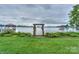 View of lake and home showing lush landscaping and walkway to the lake at 7945 Placid Ct, Denver, NC 28037