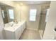 Modern bathroom with dual sinks, tile flooring, a large mirror, and walk-in shower with glass door at 8060 Scarlet Maple Ln, Tega Cay, SC 29708