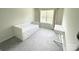 Clean bedroom featuring white daybed with storage and a small writing desk near the window at 8060 Scarlet Maple Ln, Tega Cay, SC 29708