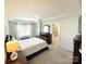Inviting bedroom with tray ceilings, neutral walls, carpet flooring, dark furniture, and natural light at 8060 Scarlet Maple Ln, Tega Cay, SC 29708