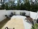 Concrete patio with seating area, a grill, privacy fence, and manicured landscaping for outdoor enjoyment at 8060 Scarlet Maple Ln, Tega Cay, SC 29708
